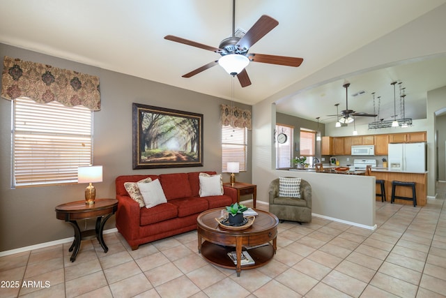 living room with lofted ceiling, light tile patterned floors, and ceiling fan