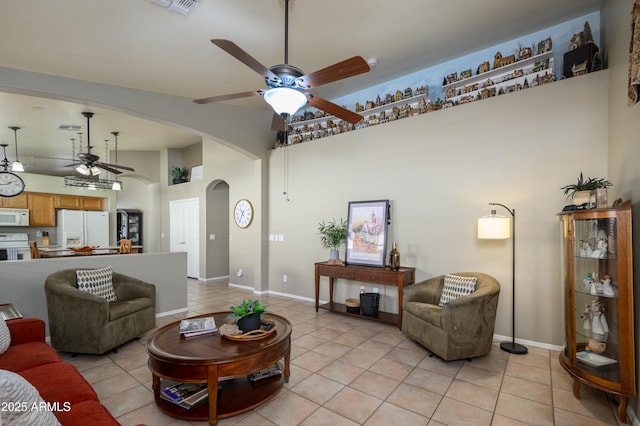 living room featuring light tile patterned floors, high vaulted ceiling, and ceiling fan