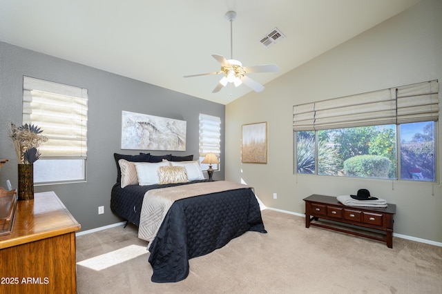 bedroom featuring vaulted ceiling, light carpet, and ceiling fan