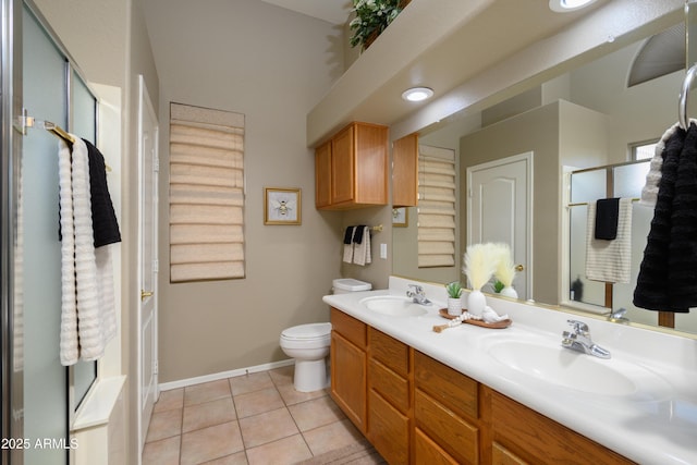 bathroom featuring walk in shower, tile patterned floors, toilet, and vanity