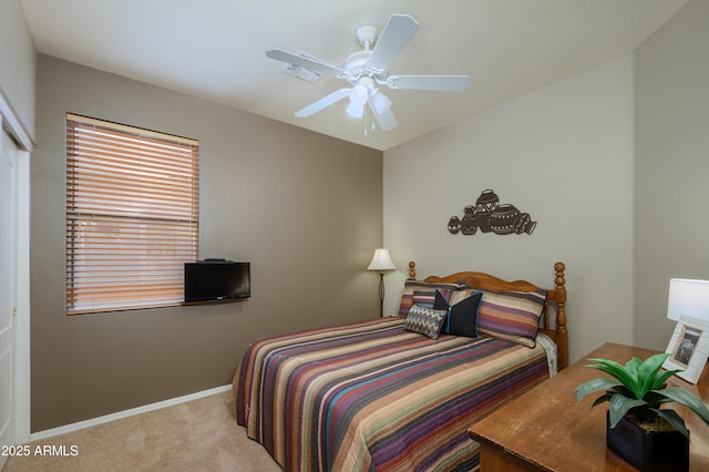 bedroom featuring light colored carpet, a closet, and ceiling fan