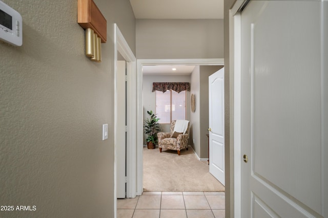 hall featuring light colored carpet