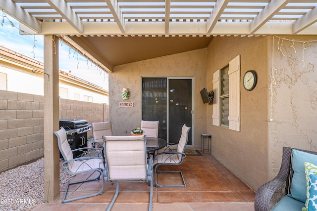 view of patio featuring a grill and a pergola