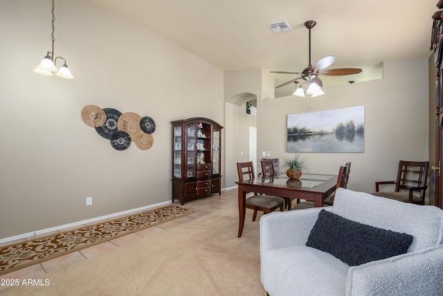 dining area featuring ceiling fan, high vaulted ceiling, and light tile patterned floors