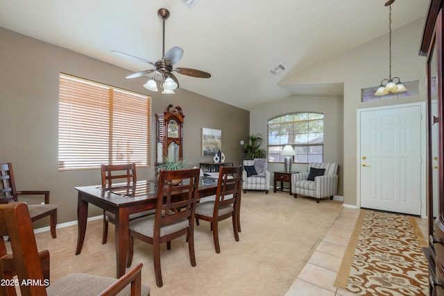 tiled dining room with lofted ceiling and ceiling fan