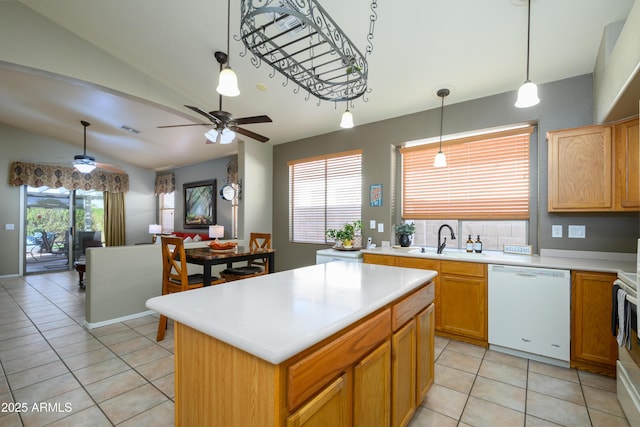 kitchen with sink, a center island, vaulted ceiling, hanging light fixtures, and dishwasher