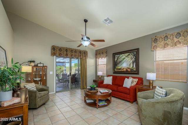 living room with lofted ceiling, light tile patterned floors, and ceiling fan