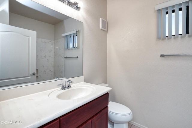 bathroom with toilet, visible vents, and vanity