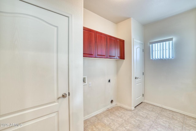 laundry area with washer hookup, cabinet space, electric dryer hookup, and baseboards