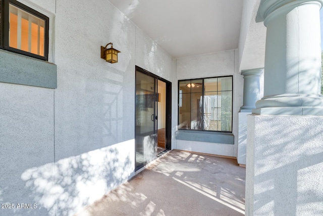 entrance to property featuring stucco siding