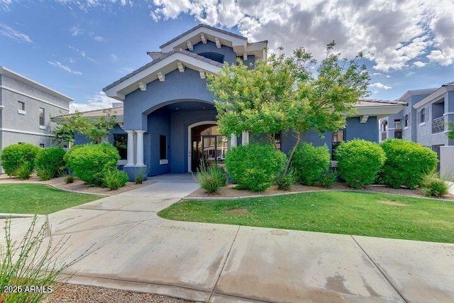 view of front of property with a front yard and stucco siding