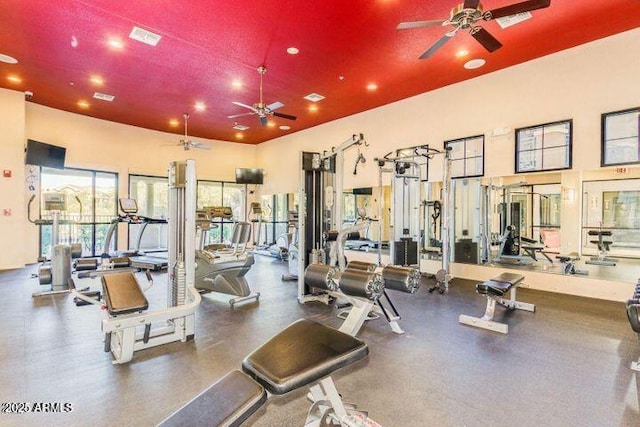 gym featuring a high ceiling, visible vents, and a ceiling fan