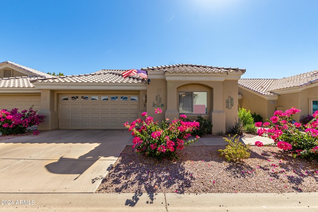 mediterranean / spanish-style home with a garage