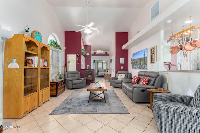 living room with high vaulted ceiling, light tile patterned flooring, and ceiling fan with notable chandelier