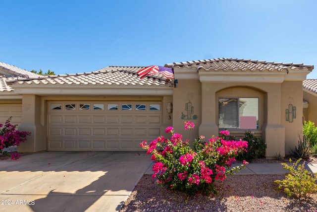 mediterranean / spanish house featuring a garage