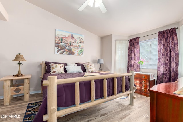 bedroom featuring ceiling fan, vaulted ceiling, and light hardwood / wood-style floors