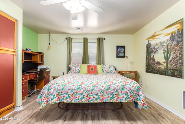 bedroom with ceiling fan and light hardwood / wood-style flooring