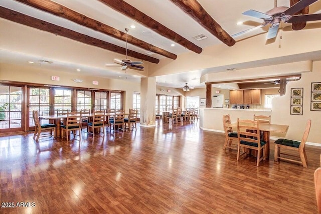 dining space featuring ceiling fan, hardwood / wood-style floors, and beam ceiling