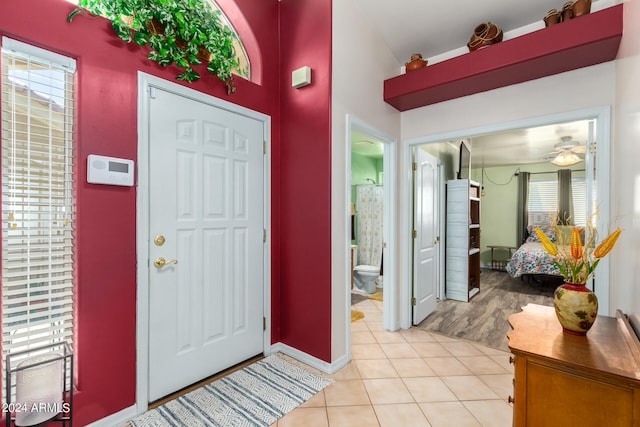 tiled entrance foyer with ceiling fan