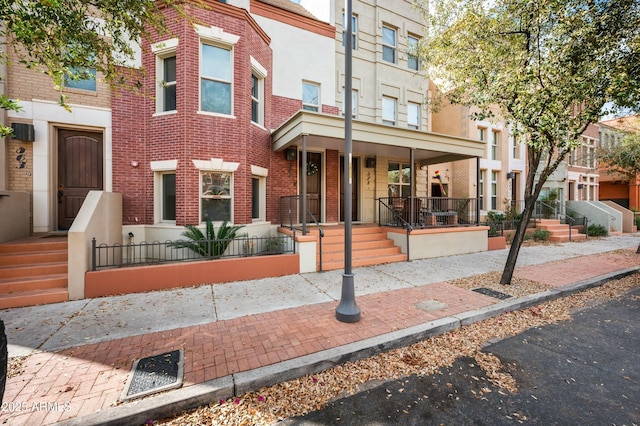 view of property with stucco siding and brick siding