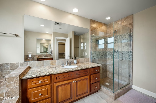 full bath featuring tile patterned flooring, a shower stall, vanity, and visible vents