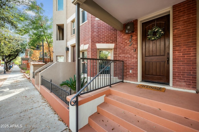 property entrance with brick siding