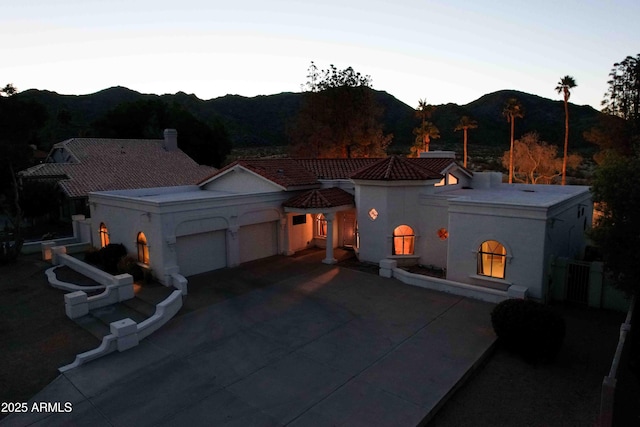 3738 E Kachina Dr, Phoenix, AZ 85044 - view of front of home with a mountain view, an attached garage, stucco siding, and concrete driveway