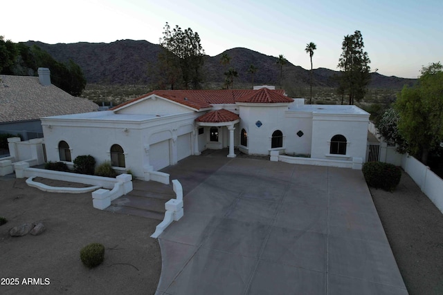 3738 E Kachina Dr, Phoenix, AZ 85044 - mediterranean / spanish-style house with an attached garage, a mountain view, concrete driveway, and stucco siding