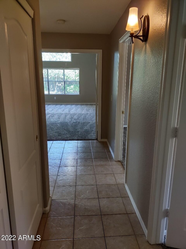 hall with tile patterned flooring