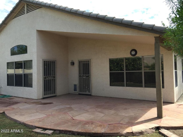 rear view of property featuring a patio area