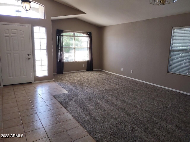 foyer featuring light colored carpet and lofted ceiling