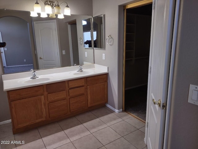 bathroom featuring a chandelier, vanity, and tile patterned floors