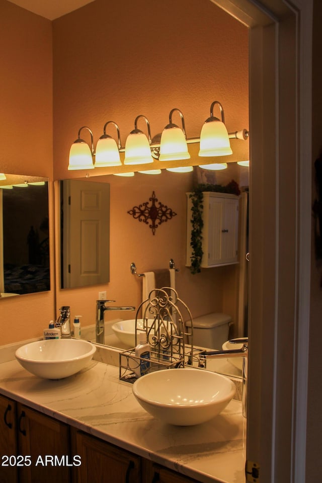 bathroom featuring vanity and toilet