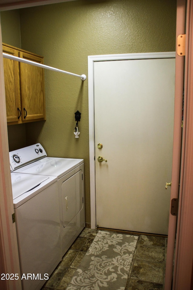 washroom with cabinets and independent washer and dryer