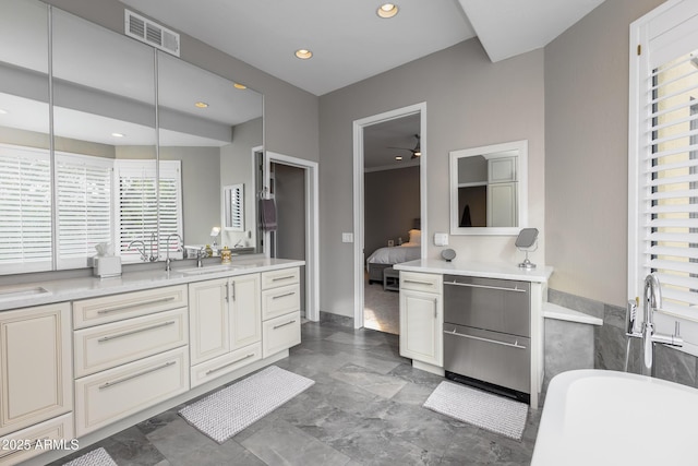 bathroom with vanity and a tub