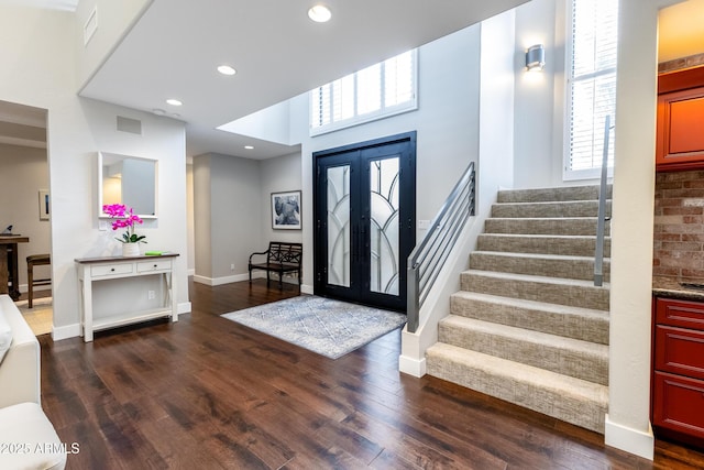 entrance foyer with dark hardwood / wood-style flooring and french doors