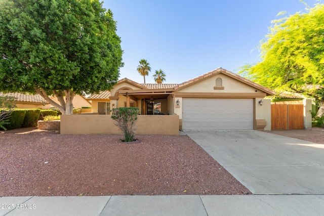 6430 E Riverdale St, Mesa, AZ 85215 - view of front of home with stucco siding, an attached garage, concrete driveway, and a tiled roof