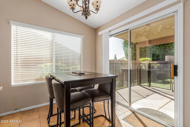 6430 E Riverdale St, Mesa, AZ 85215 - dining space featuring lofted ceiling, light tile patterned floors, a chandelier, and baseboards