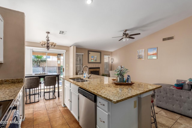 6430 E Riverdale St, Mesa, AZ 85215 - kitchen with appliances with stainless steel finishes, lofted ceiling, open floor plan, a sink, and white cabinets