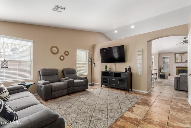 6430 E Riverdale St, Mesa, AZ 85215 - living room featuring lofted ceiling, arched walkways, baseboards, and recessed lighting