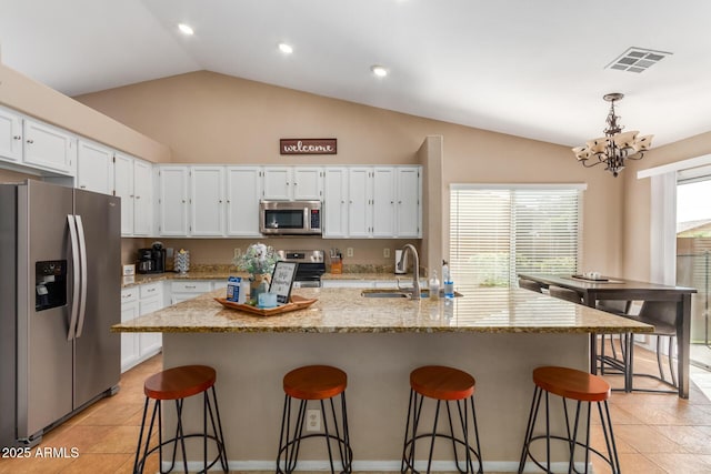 6430 E Riverdale St, Mesa, AZ 85215 - kitchen featuring appliances with stainless steel finishes, a sink, a chandelier, lofted ceiling, and white cabinets