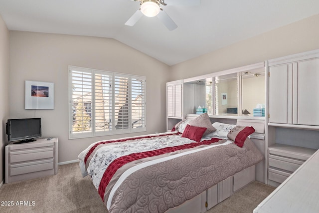 carpeted bedroom with vaulted ceiling and ceiling fan