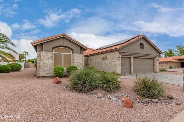 mediterranean / spanish home featuring a garage