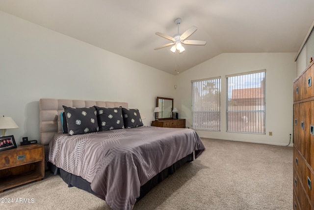 bedroom featuring lofted ceiling, light colored carpet, and ceiling fan