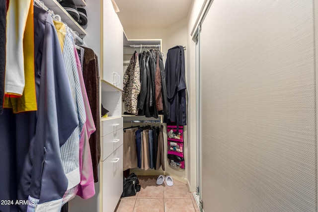 walk in closet with light tile patterned flooring