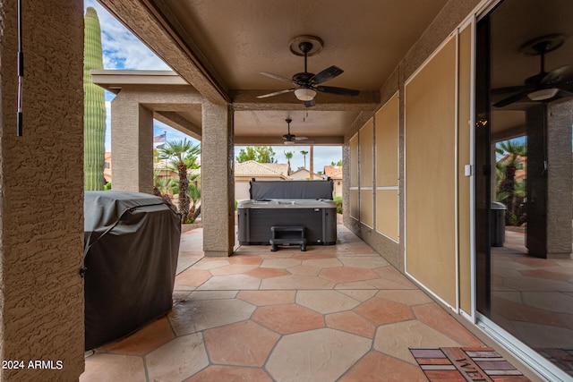 view of patio / terrace with area for grilling, ceiling fan, and a hot tub