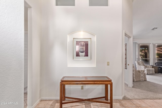 hall featuring light tile patterned floors