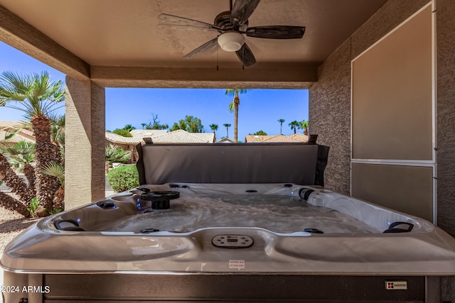 view of patio / terrace with ceiling fan and a hot tub