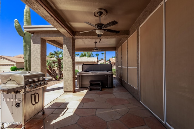 view of patio / terrace with a grill, ceiling fan, and a hot tub