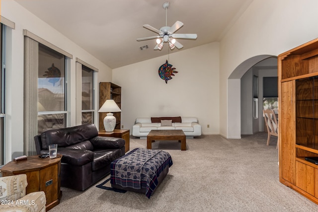 carpeted living room with high vaulted ceiling and ceiling fan